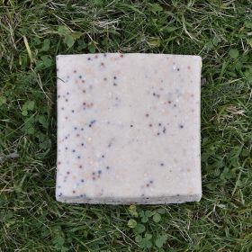 One white Suet Block lying on grass
