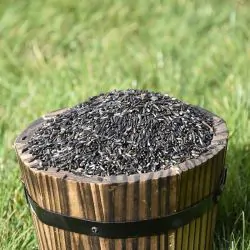 Small wooden bucket filled with Niger Seed for Birds