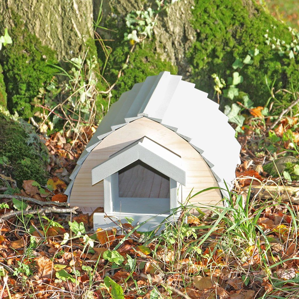 Blue wooden hedgehog barn laying on ground
